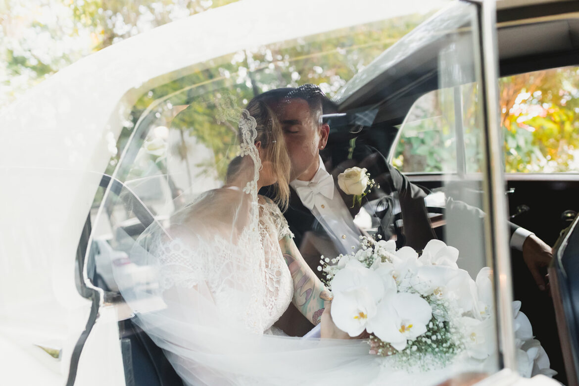 Couple kissing in car on wedding day at Villa Woodbine